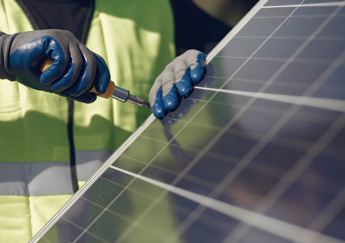 Worker installing a solar panel